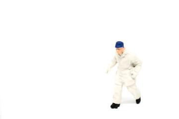 Miniature people firemen construction concept on white background with a space for text