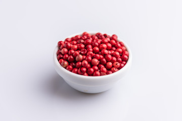 angle view,white bowl,aromatic,background,berry,brazil,closeup,color,condiment,cuisine,dry,exotic,flavor,food,heap,ingredient,isolated,macro,natural,over,pepper,peppercorn,peppercorns,peppers,pile,pin