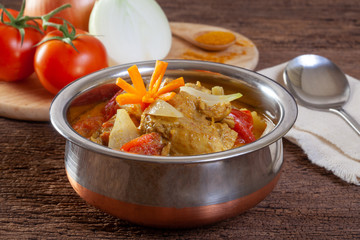 Chicken curry on wooden background