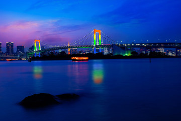 Naklejka na ściany i meble Colorful illuminations at Rainbow Bridge from Odaiba in Tokyo, Japan