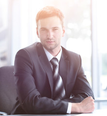 Fototapeta premium portrait of confident businessman sitting behind a Desk