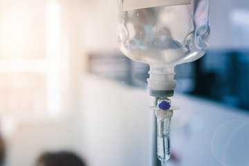 Healthcare concept, Close up of medical drip or IV drip chamber in patient room, Selective focus. - obrazy, fototapety, plakaty