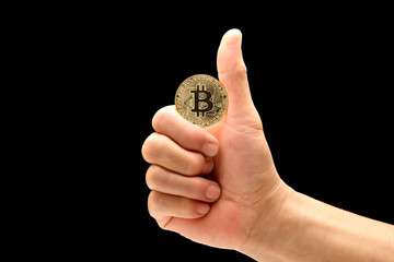 man hand in good symbol to holding bitcoin isolated on black background
