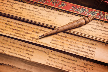 pen for writing text on Bai Lan background, Bai Lan or ancient palm leaf manuscripts content about buddhist scriptures, Pali language Khmer