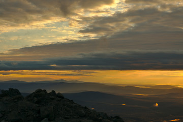 Mountains during sunrise and glowing fog in the valleys. Beautiful natural panoramic landscape
