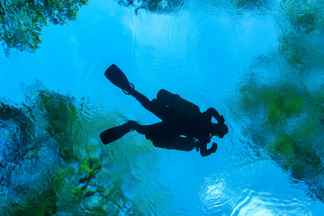 Silhouette of a Side Mount diver at a Florida Spring