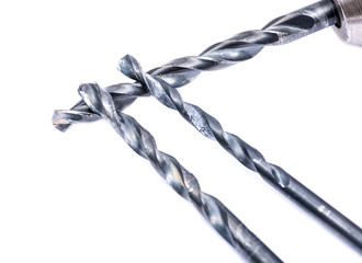 Old drill gun with used drill bit isolated on white background