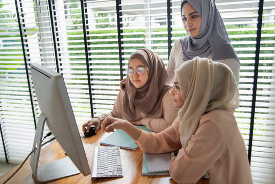 Muslim students using and learning with computer.
