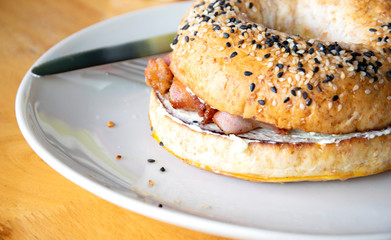 Bagel sandwiches with cream cheese and fried bacon