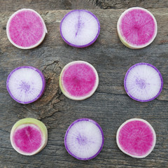 Obraz na płótnie Canvas square image of nine large colorful purple, radish slices