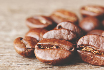 Roasted coffee beans on wood background