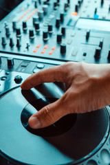 image of Dj playing music at mixer closeup