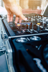 image of Dj playing music at mixer closeup