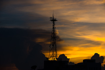 Silhouette of cellular tower with golden hour Evening sky and Clouds