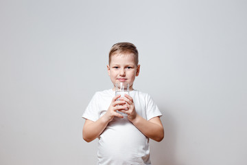 happy cute boy in white t-shirt holding a glass glass glass glass of drinking water on white background