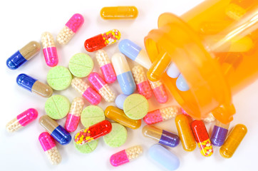 Medicine in light protected bottle. Capsules in orange bottle. Refill prescription concept.