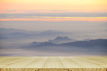 Fototapeta na wymiar Perspective wood table with mountain and the mist view.
