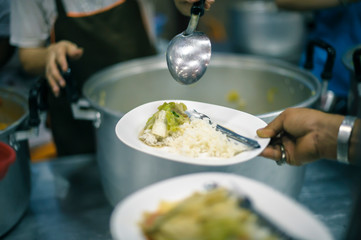 The hands of the poor receive food from the hands of the philanthropist : concept of giving