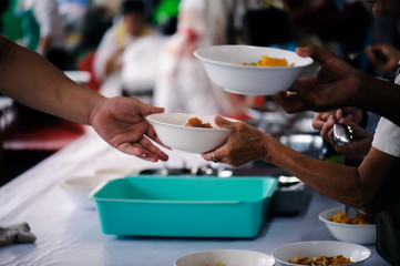 The hands of the poor receive food from the hands of the philanthropist : concept of giving