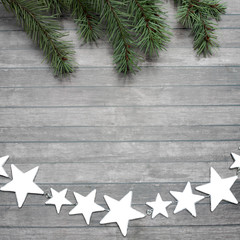 Silver star's garland and branches of fir-tree. © Evgeniia