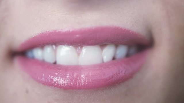 Close up of beautiful smiling pink lips of young girl with open mouth and teeth. 3840x2160
