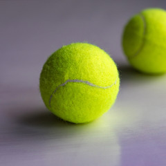 Yellow tennis ball with reflection below