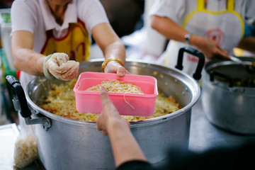 Volunteers provide food for beggars: Concepts Feeding and help