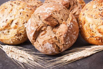 Wholegrain crunchy rolls for breakfast and ears of rye or wheat grain