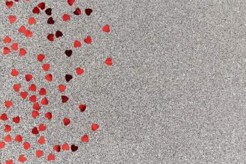 Silver background with red confetti hearts for Valentine Day
