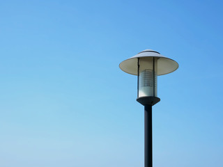 Low Angle View of Electric Lighting Post Against Clear Blue Sky