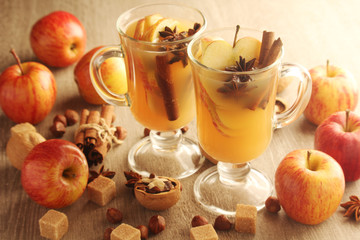 Two cups with hot cider in cold season with cinnamon and anise