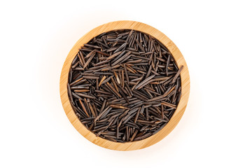 Black wild rice, shot from above in a wooden bowl on a white background with a place for text