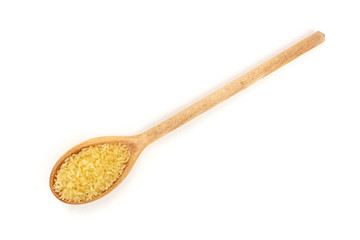 An overhead photo of integral brown rice in a wooden spoon, shot from the top on a white background with a place for text