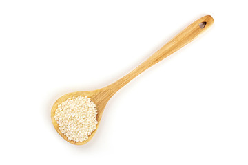 An overhead photo of Spanish calasparra rice used for paella in a wooden spoon, shot from the top on a white background with a place for text