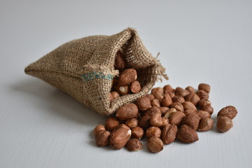 Hazelnuts in the sack on the white background