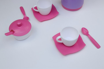 children's toy dishes for tea on a white background