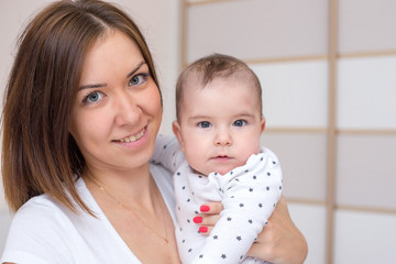 young mother is holding her newborn baby