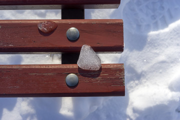 Icicle on the bench, the beginning of winter