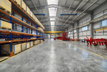 Large, spacious assembly shop. High storage racks with wooden boxes - obrazy, fototapety, plakaty