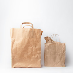 Various kraft paper bags and wrapping paper isolated on white background