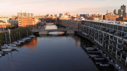 Fototapeta premium Milwaukee river in downtown, harbor districts of Milwaukee, Wisconsin, United States. Real estate, condos in downtown. Aerial view, drone flying