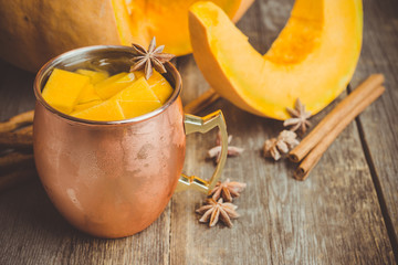 Fresh pumpkin cocktail in copper mug. Selective focus. Shallow depth of field.