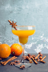 Tasty pumpkin margarita cocktail on the rustic background. Selective focus. Shallow depth of field.