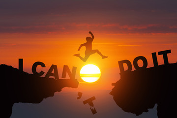 Person jumping on I can do it or I can't do it text over cliff on sunrise background,Business idea concept,vintage tone.