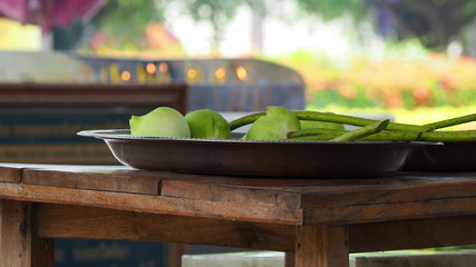 Lotus placed in pan On the table prepared for the worship of the Buddha.The background has candles and smoke incense.