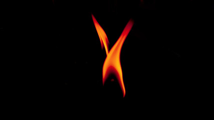 Flame from the candle orange color In black background, Look hot in the shadows. Concept: All the dark things have light and way always.