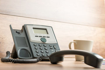 Black landline telephone with handset off line