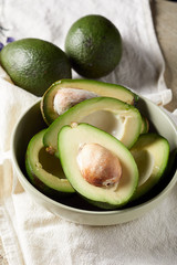 Overhead view of sliced avocado on napkins. Raw avocado. Healthy food
