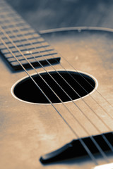 Obraz premium Vintage acoustic guitar on a wooden floor with colour toning