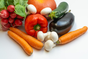 Pumpkin, eggplant, carrots, mushrooms, pepper, radish and courgette on white background